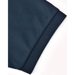 A close-up of a dark blue polo shirt sleeve featuring a textured finish and a logo.
