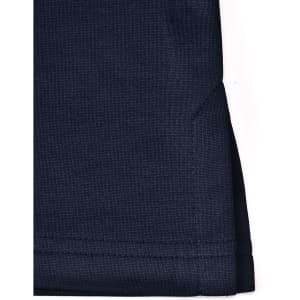 A navy polo shirt featuring a side vent detail and a logo on the fabric.