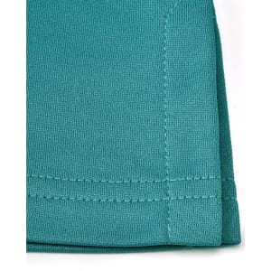 A close-up of a teal sustainable poly/cotton polo shirt showing the fabric texture and stitching details.