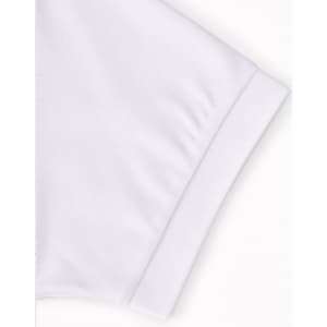 A white polo shirt featuring a fold-over collar and cuff, with a logo on the sleeve.