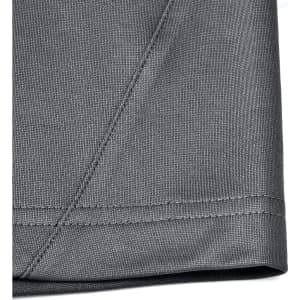 A close-up of the hem and fabric of a grey men's sustainable polo shirt, featuring a stitched edge.