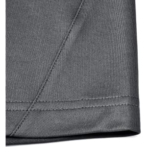 A close-up of the hem and stitching of a grey polo shirt made from sustainable poly/cotton fabric.