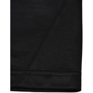 A close-up view of the hem of a black polo shirt, featuring subtle stitching details and a logo.