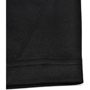 A black fabric close-up featuring a contrast stitch, showcasing texture and seam detail of a polo shirt.