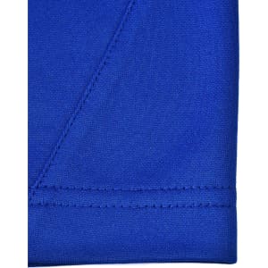 A close-up of a vibrant blue polo shirt featuring contrasting stitching. The fabric is a sustainable poly/cotton blend.