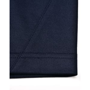 A close-up of a navy blue sustainable poly/cotton polo shirt, showcasing stitching and fabric texture.