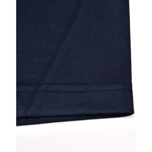 A close-up of a navy blue polo shirt featuring contrast stitching and a logo.