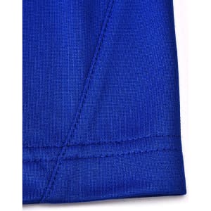 A close-up of a blue polo shirt featuring contrast stitching and a tag with a logo.