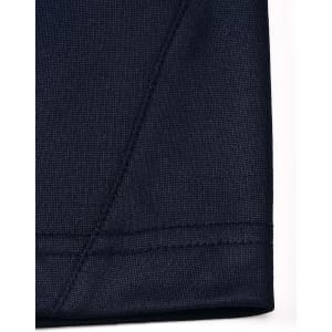 A close-up view of a navy polo shirt sleeve featuring a contrasting seam and stitching detail.