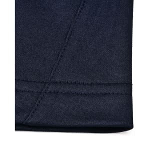 A close-up of the hem of a navy polo shirt showcasing the fabric texture and stitching detail.