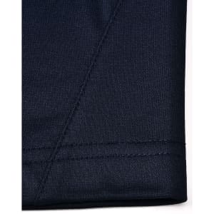 A close-up of the navy fabric of a polo shirt showcasing textured stitching details.