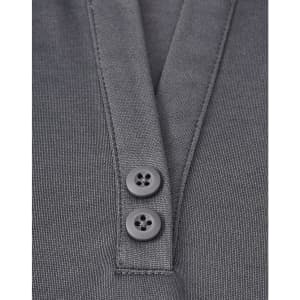 A close-up of a grey polo shirt featuring a placket with two black buttons and a sustainable fabric blend.