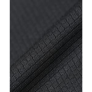 A close-up of textured black fabric, showcasing a sustainable jacquard knit pattern. Featuring a subtle sheen, it has a fabric brand logo.
