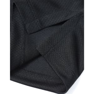 A close-up of a black men's jacquard knit polo, highlighting the textured fabric and stitching details.