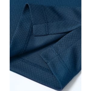 A close-up of a deep navy Jacquard knit fabric with detailed stitching and an edge finish. Features a branding logo.