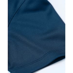A close-up of a navy blue jacquard knit fabric, featuring a smooth texture and intricate pattern.