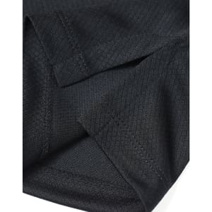 A close-up of a black Jacquard knit fabric showing sleeve details and stitching. It features a logo.