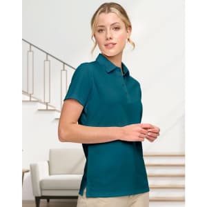 A teal ladies' sustainable jacquard knit short-sleeve polo shirt with a collar and side slits, featuring a logo.