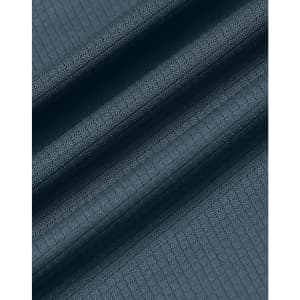 A textured fabric in a deep teal shade, featuring a jacquard knit pattern. It has a smooth finish and drapes softly.