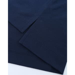 A close-up of a navy blue polo shirt displaying its fabric and hem details. The shirt has a logo.