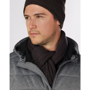 A man wearing a dark brown cable knit scarf, paired with a grey jacket and matching beanie.