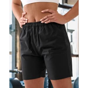 Unisex black mercerised cotton shorts with an elastic waistband, featured in a gym setting.