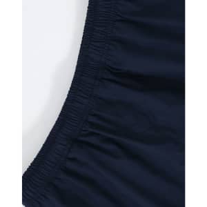 A close-up of unisex mercerised cotton shorts in navy, featuring an elastic waistband. The image includes branding.