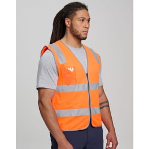 An orange high-visibility safety zip vest featuring reflective stripes and an ID pocket, worn by a model.