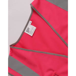 A pink high visibility safety vest featuring grey accents and utility pockets. It includes a space for ID and has a logo.
