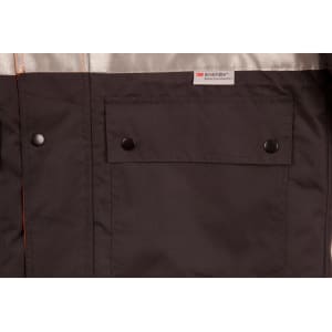 A black and grey safety jacket featuring 3M reflective tape and a front pocket with snap buttons. It has a branding label.