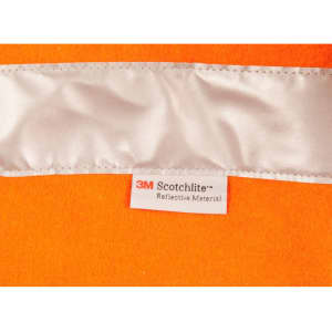 A vibrant orange safety jacket featuring reflective material and a tag indicating Scotchlite brand.