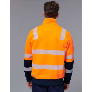 A bright orange safety jumper with reflective stripes and a navy blue collar worn from the back. It features a logo.