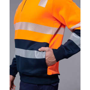 A high-visibility jumper featuring bright orange and navy blue with reflective stripes. It includes a side pocket and has a logo.