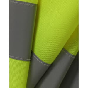 A close-up of a bright yellow safety vest featuring grey shoulder reflective tapes and textured fabric.