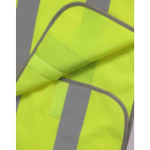 A bright yellow safety vest with grey reflective shoulder tapes, featuring contrast stitching and a soft inner lining.