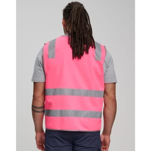 A pink safety vest with grey reflective tapes, featuring a logo, designed for high visibility.