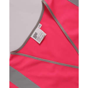 A pink safety vest featuring grey reflective shoulder tapes and a label inside.