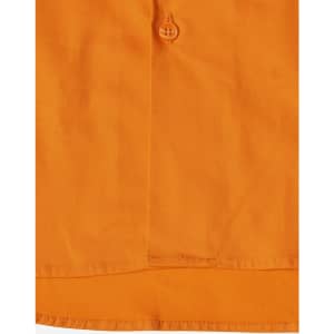 An orange work shirt with a button detail, featuring stitching and a fabric texture. It has a logo.