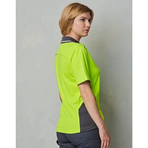 A woman wearing a bright lime green short-sleeved polo shirt with grey accents and a logo.