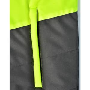 A hi-vis quilted safety jacket featuring a bright yellow upper and dark grey lower section, with a hanger loop.