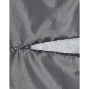 A close-up of a grey quilted fabric featuring a zippered section and a soft, light grey lining.