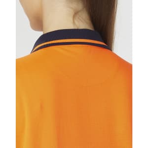 A close-up of a bright orange polo shirt with a navy collar and stripes, featuring a logo.