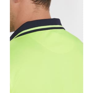 A close-up of the collar of a unisex hi-vis polo shirt in fluorescent yellow with navy detailing.