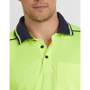 A close-up of a bright yellow unisex polo shirt with navy collar detailing and a pocket. It includes a logo.
