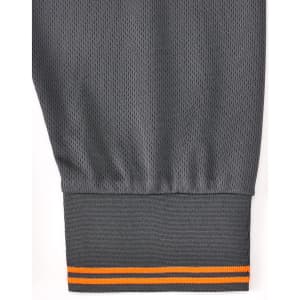 A grey long-sleeve polo shirt featuring segmented detailing with an orange stripe at the cuff. It has a logo on the garment.
