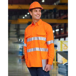 An orange long-sleeve work shirt featuring reflective stripes, worn by a smiling person in a construction setting.