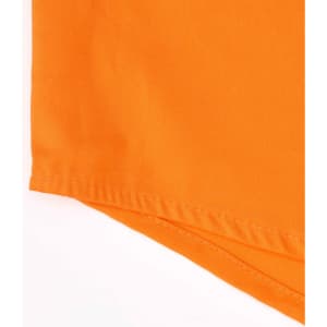 An orange closed front long-sleeve shirt with perforated tape detail and a branding logo.