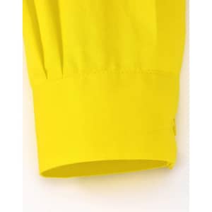 A close-up of a yellow long-sleeved shirt sleeve cuff, featuring a smooth fabric and a logo.