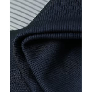A close-up of textured, dark navy fabric with a ribbed pattern, showcasing its soft and flexible quality.