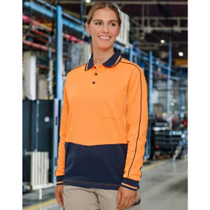 A long-sleeve polo in hi-vis orange and navy, featuring a logo, set in an industrial environment.